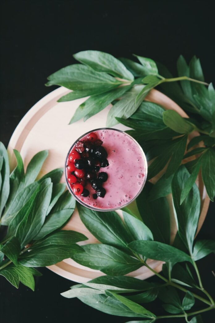 clear drinking glass with juice on white plate