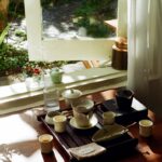 일상 속 스트레스, ‘작은 변화’가 해답… 실천 가능한 관리법 주목받아 Tea set arranged on a wooden tray by the window.