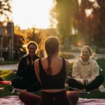 여성 건강관리, 새로운 라이프스타일 트렌드로 자리잡다 a group of people sitting on top of a lush green field