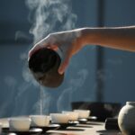 디지털 시대, 대체요법의 새로운 진화…온라인 상담과 AI로 확장되는 웰빙 트렌드 person pouring hot water on white cup