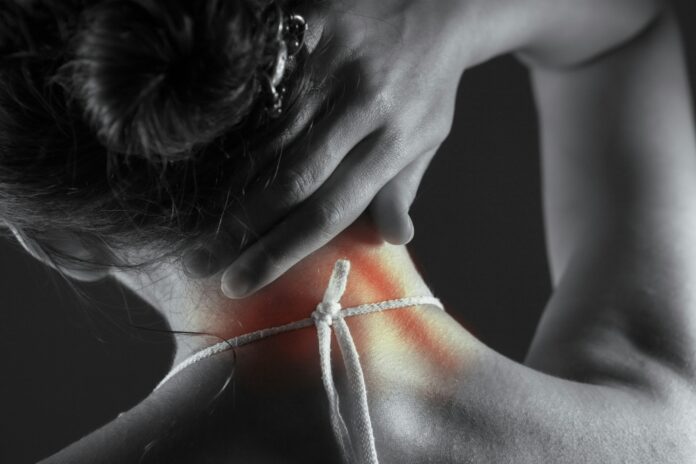Photo by Sasun Bughdaryan Woman's neck with highlighted pain area.