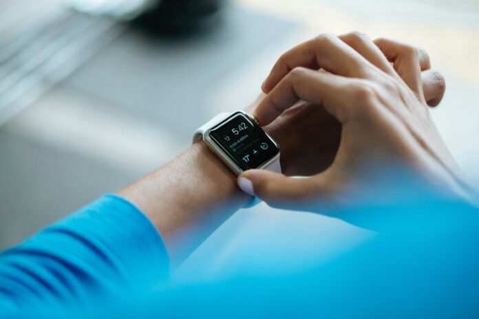 Photo by Luke Chesser person clicking Apple Watch smartwatch