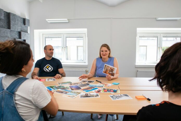 a group of people sitting around a wooden table